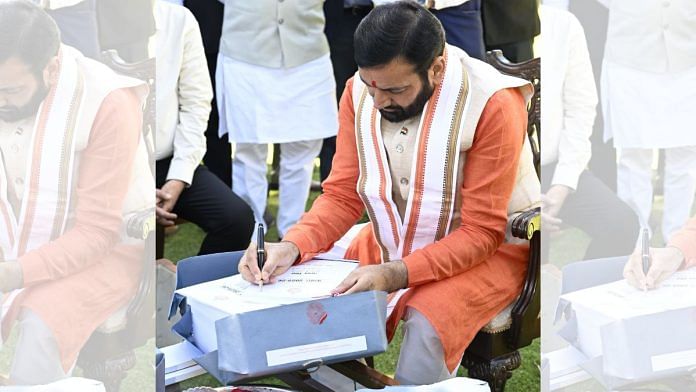Haryana Chief Minister Nayab Singh Saini signs the budget for FY 2025-26 before presenting in the state assembly | X: @NayabSainiBJP