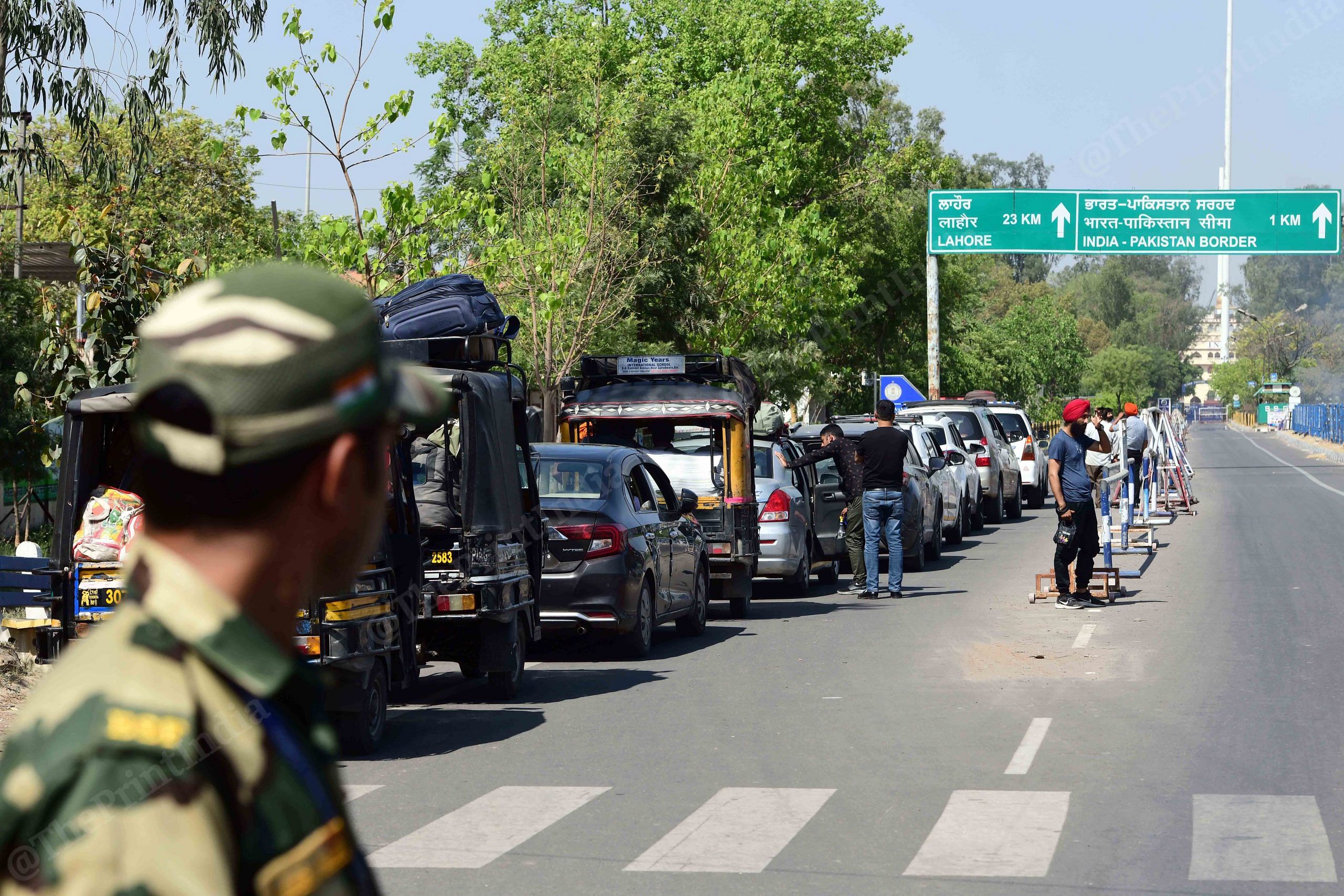 A military personnel with the Border Security Force stands guard, as vehicles having Pakistani citizens line up near the Integrated check post, as they prepare to leave India after India revoked visas issued to Pakistani citizens, at the Attari-Wagah border crossing near Amritsar | Photo: Suraj Singh Bisht, ThePrint 