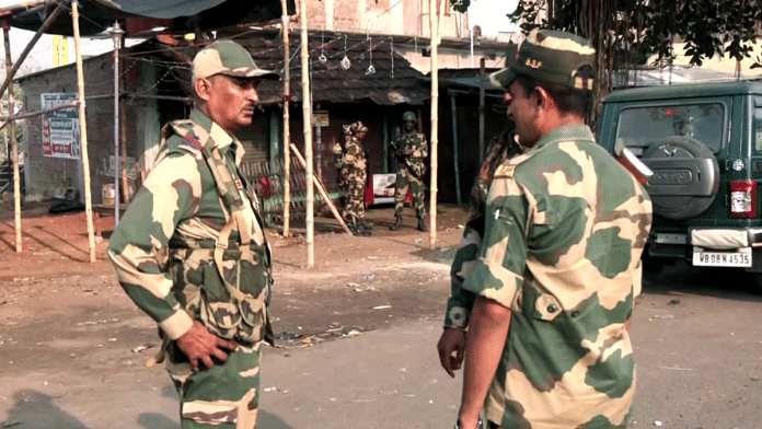 Security personnel stand guard after violent protests against the Waqf (Amendment) Act, at Dhuliyan in Murshidabad on Saturday. Three people killed in the violent protests | ANI