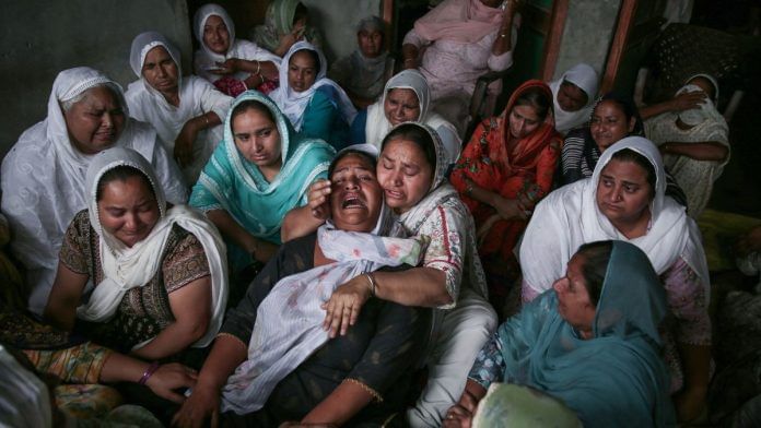 Jasbir Kaur, wife of Sukhwinder Singh, who died after consuming spurious liquor, mourns at a Majitha village in Amritsar on 13 May, 2025. Reportedly, 14 people died and 6 hospitalised after allegedly consuming the liquor | ANI/Raminder Pal Singh