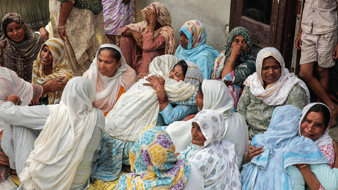 Family members of Sarabjit Singh, who lost his life after consuming spurious liquor, being consoled by relatives, at Mardi Kalan village in Amritsar on Tuesday. Reportedly, 14 people died and 6 hospitalised after allegedly consuming the liquor in villages of Majitha area. | ANI