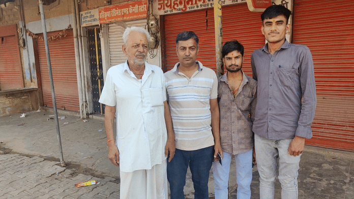 Rawal Ram (extreme left) and Om Prakash (next to Rawal Ram) along with two other local residents in Pokharan town. Shops remain closed in the background | Krishan Murari | ThePrint