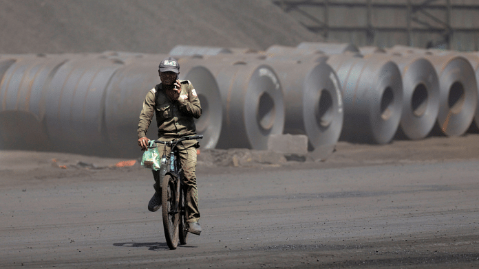 A cyclist rides past unloaded steel coils at the Deendayal Port in Kandla, in the western state of Gujarat, India, April 5, 2025 | Representational image | Reuters