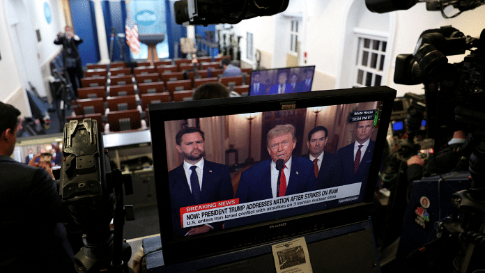 A screen displays U.S. President Donald Trump delivering an address to the nation, following U.S. strikes on Iran's nuclear facilities, at the White House in Washington, D.C., U.S. on 21 June 2025. | Kevin Mohatt | Reuters