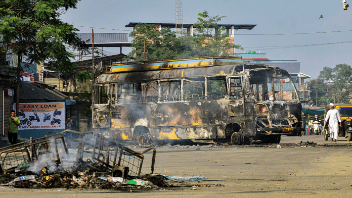 Charred remains of a bus, which was set on fire by a mob in Imphal Sunday | PTI
