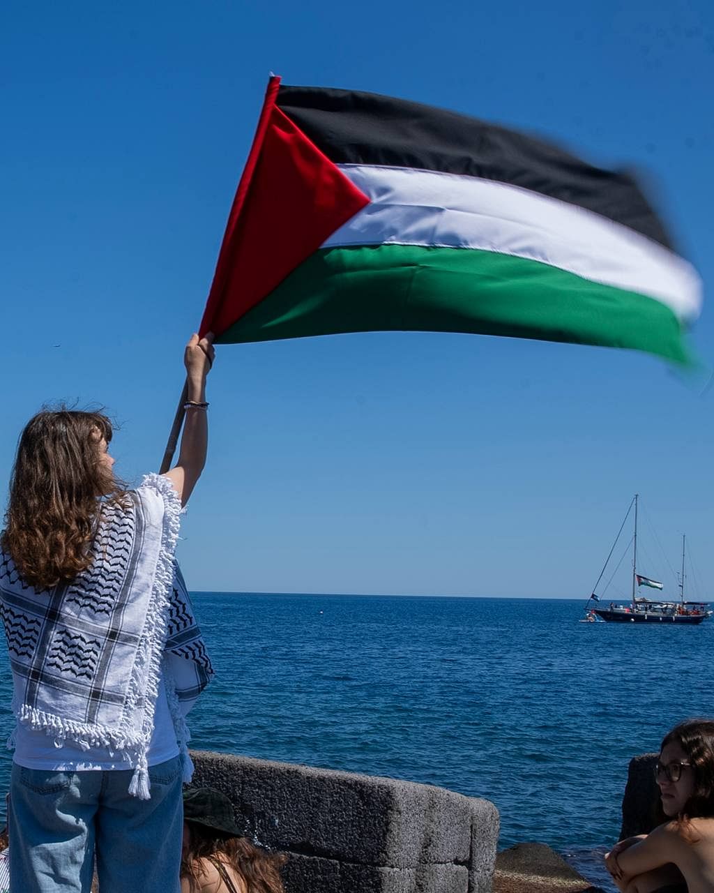 Greta Thunberg with a Palestinian flag | X/@GazaFFlotilla