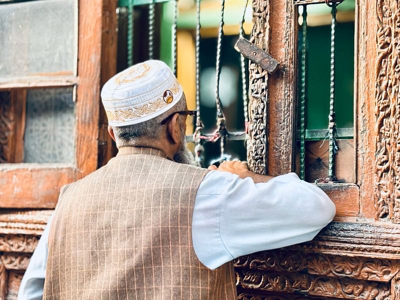 श्रीनगर के खानयार में विवादास्पद रोज़बल दरगाह के बाहर इबादत करते एक बुज़ुर्ग व्यक्ति | फोटो: अनीशा नेहरा/दिप्रिंट