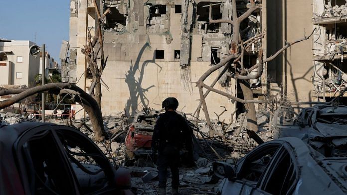 A member of the security forces stands amid debris at an impacted residential site, following a missile attack from Iran in Be'er Sheva, Israel, June 24, 2025 | REUTERS/Amir Cohen