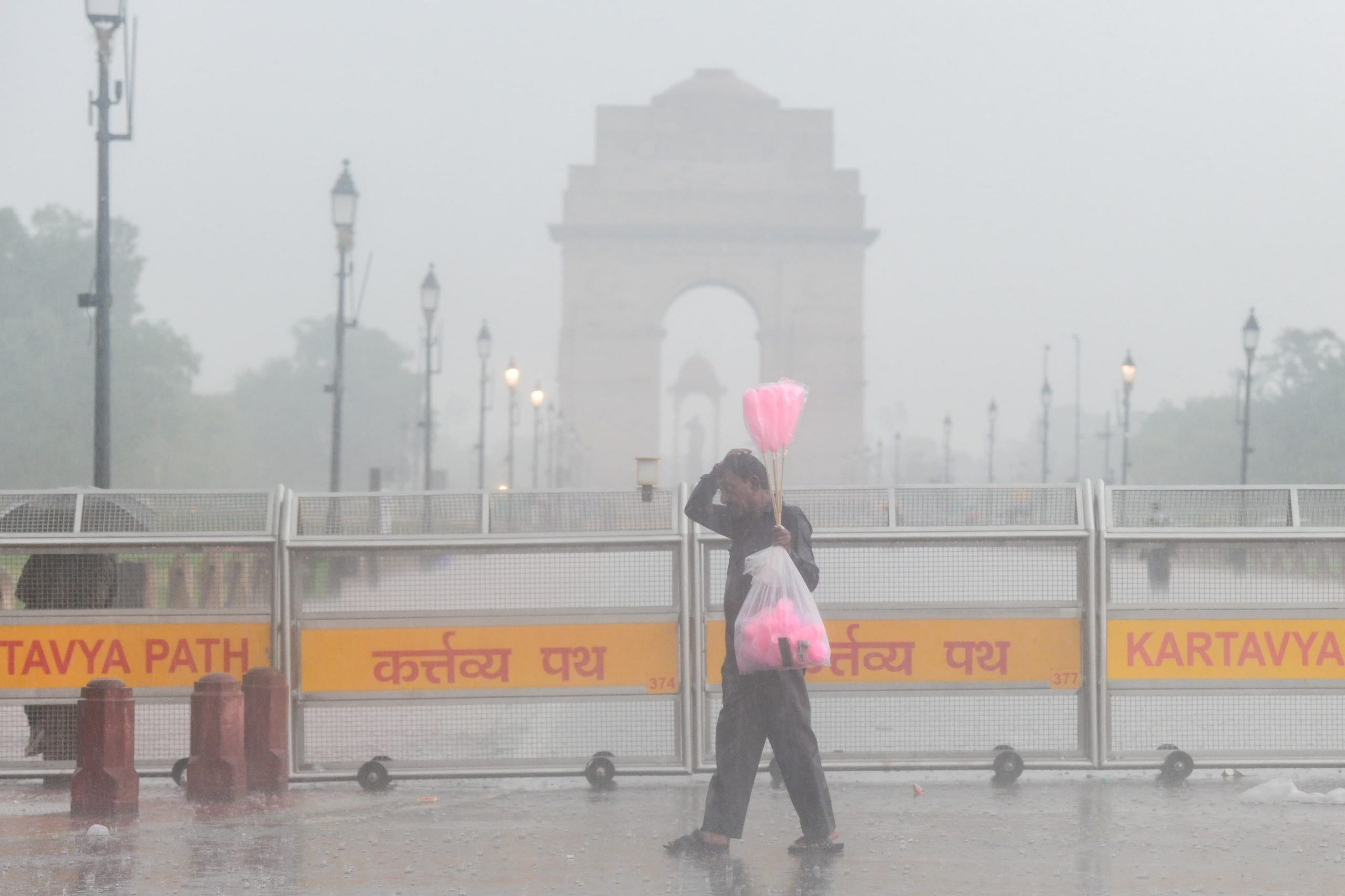 A cotton candy vendor braving the downpour as heavy rain lashes India Gate in New Delhi | Suraj Singh Bisht