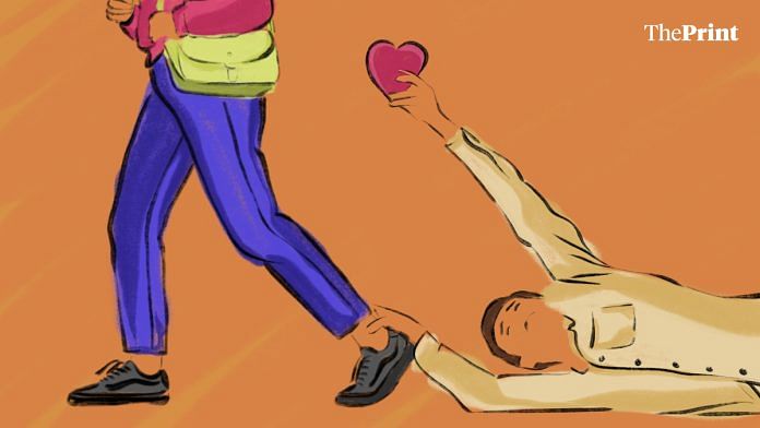 A man on the floor, holding the ankle of a woman with a heart in another, showing rejection in online dating