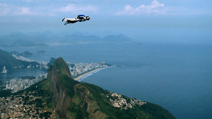 Austrian base-jumper Felix Baumgartner, 32, glides through the air past 