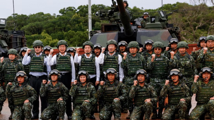 Taiwan's President Lai Ching-te poses for a group photo in front of U.S.-made M1A2T Abrams tanks after taking part in live-fire exercises in Hsinchu, Taiwan 10 July | Reuters
