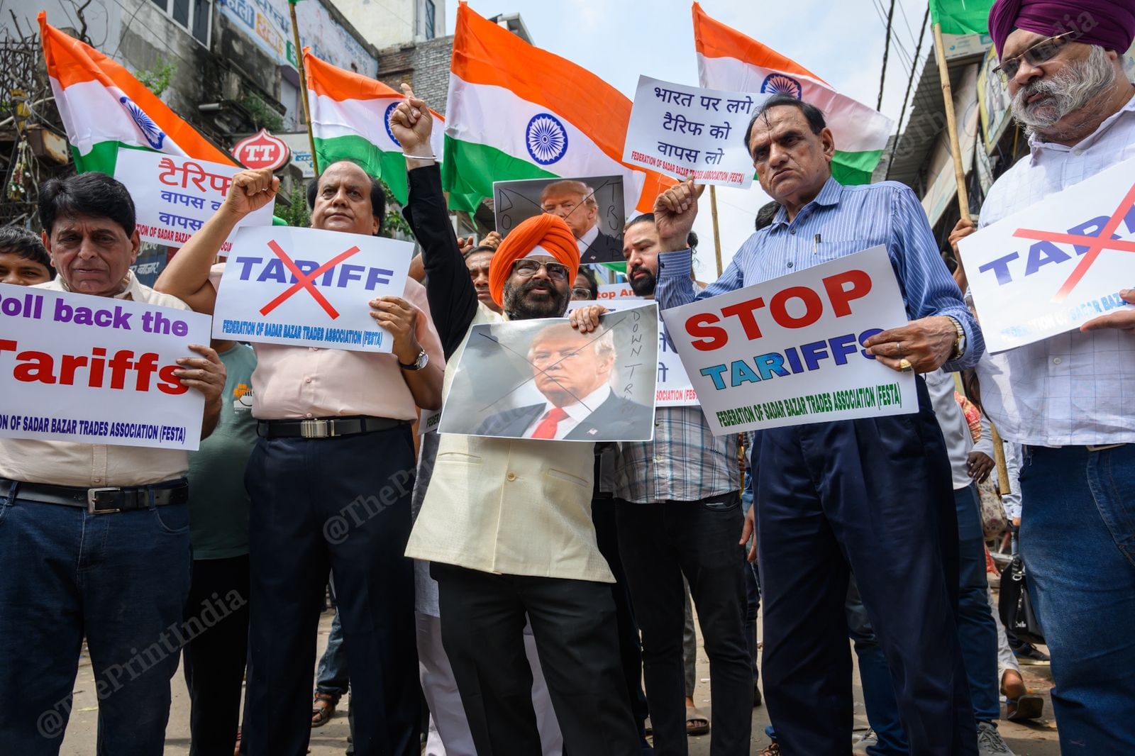 Members of Federation of Sadar Bazar Traders Association (FESTA) holding placards and raising slogans during a demonstration against tariffs imposed on Indian goods by the Trump administration, in New Delhi, on 30 August, 2025 | Ankit Roy