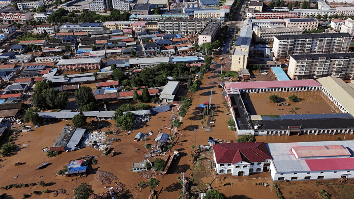 A drone view shows partially submerged village houses and other buildings after heavy rainfall flooded the area, in Miyun district of Beijing, China on 29 July 2025. | File Photo | Florence Lo | Reuters