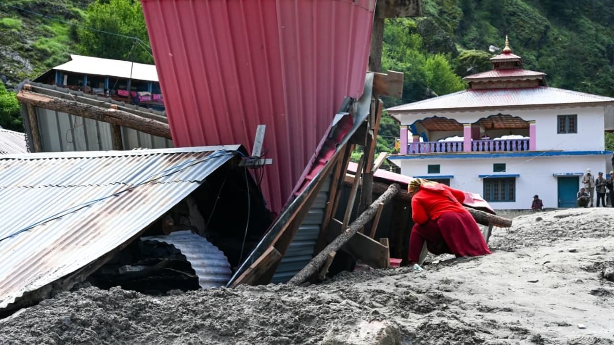 A woman digs through the debris to recover her possessions | Suraj Singh Bisht | ThePrint