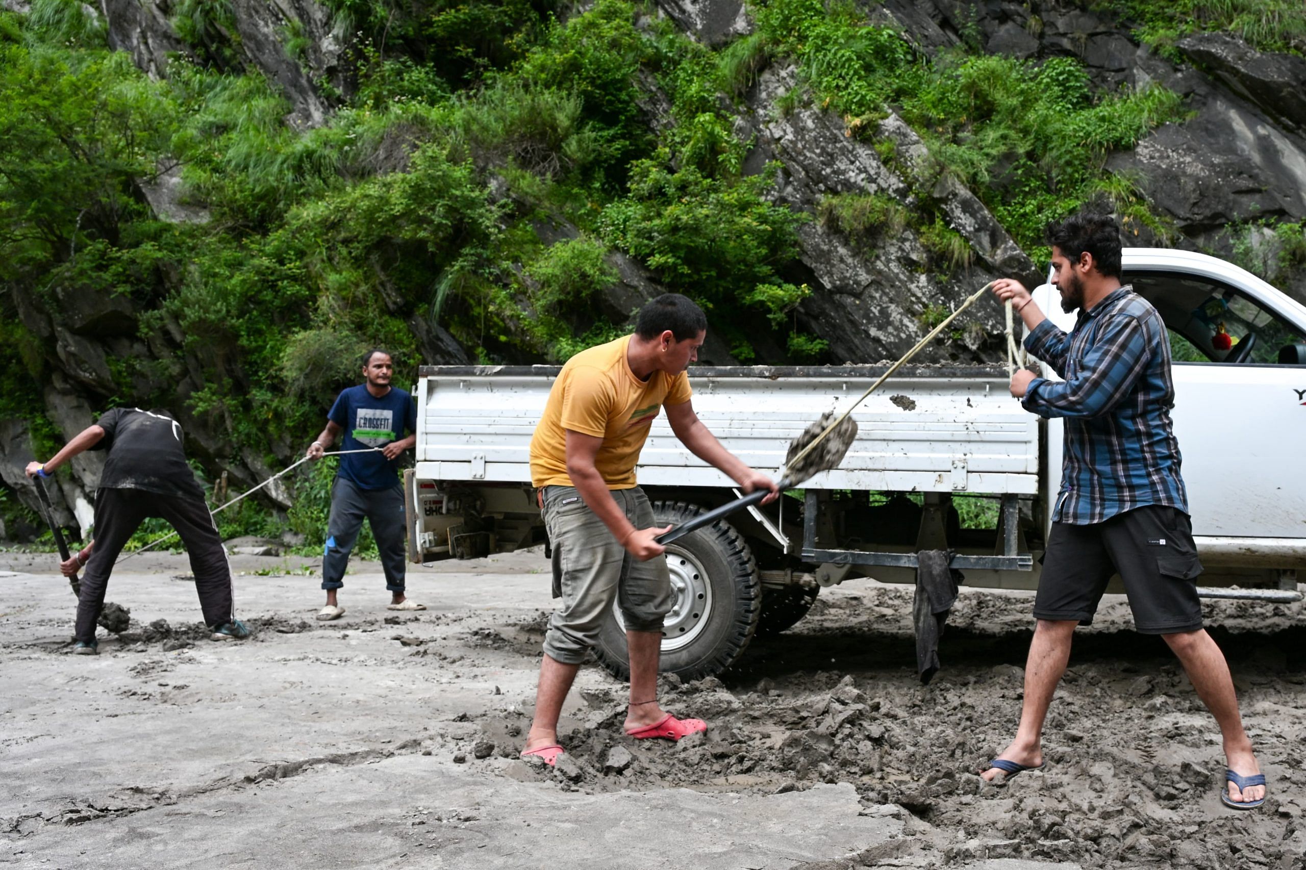  Workers clearing the debris from the road | Photo: Suraj Singh Bisht | ThePrint