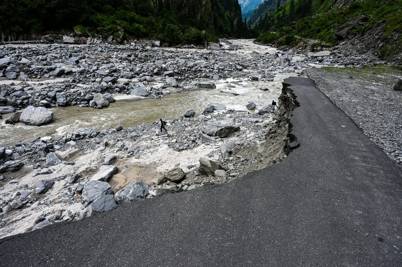 Local villagers walking along the banks of the Bhagirathi river after roads were damaged | Photo: Suraj Singh Bisht | The Print