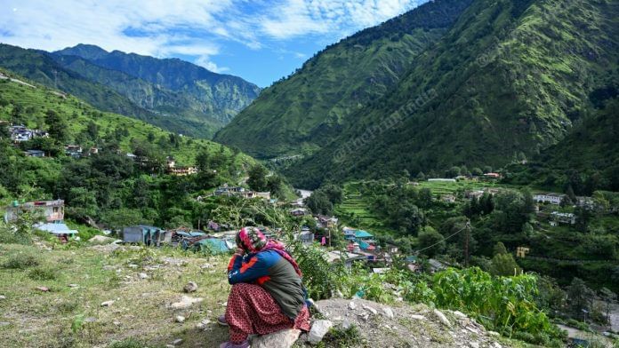 Kala Devi peers at the sky, waiting for the helicopter that could ferry her back to her family in Uttarakhand's Dharali village; she and her husband Peer Singh, both originally from Nepal, were among the few who survived the flash flood that struck Uttarkashi on 5 August, 2025 | Suraj Singh Bisht | ThePrint