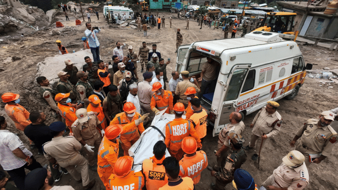 NDRF personnel carry mortal remains of a victim during search and rescue operation at cloudburst-hit Chisoti village, in Kishtwar district, Jammu and Kashmir | PTI