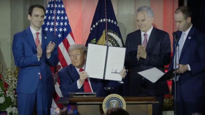 US President Donald Trump holding up an executive order at AI Summit in Washington DC on 24 July, 2025 | YouTube @White House