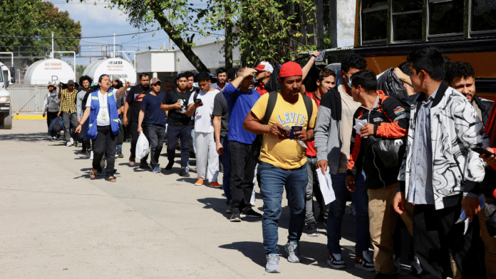 Honduran migrants deported from the United States wait in line to board a bus at the Center for Attention to Returned Migrants, in San Pedro Sula, Honduras January 30, 2025 | Reuters