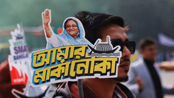 File photo of a student holding a placard of Sheikh Hasina on the formation day of Bangladesh Chhatra League, the student wing of Bangladesh Awami League | Reuters