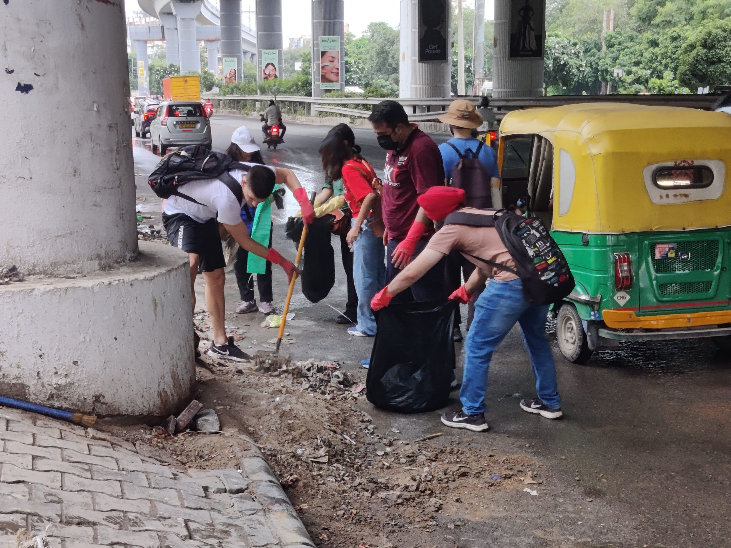 Auto drivers and commuters often stop to watch the group cleaning the area