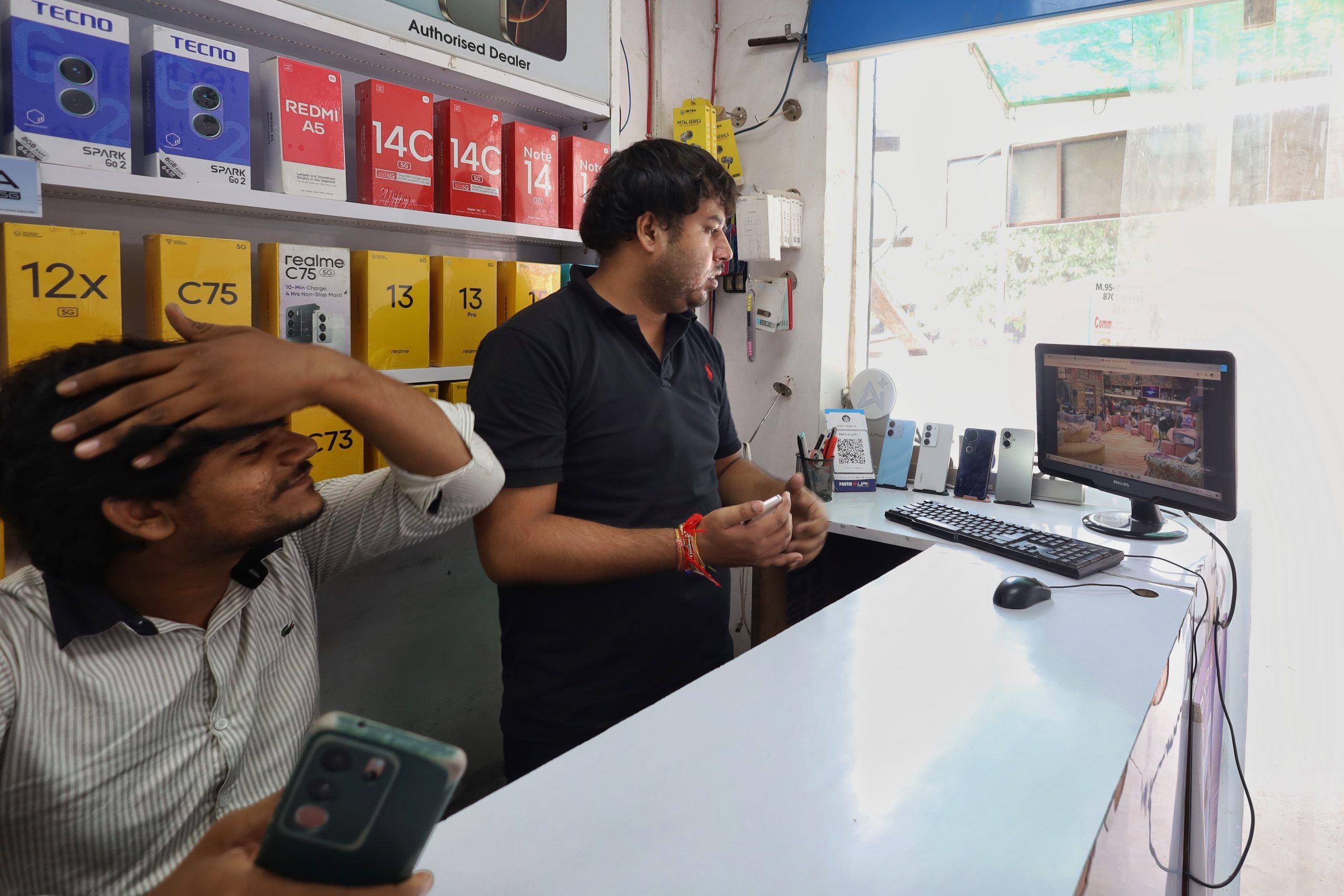 Rohit Nagar and Parvesh Pal at their mobile repair shop in Greater Noida’s Surajpur