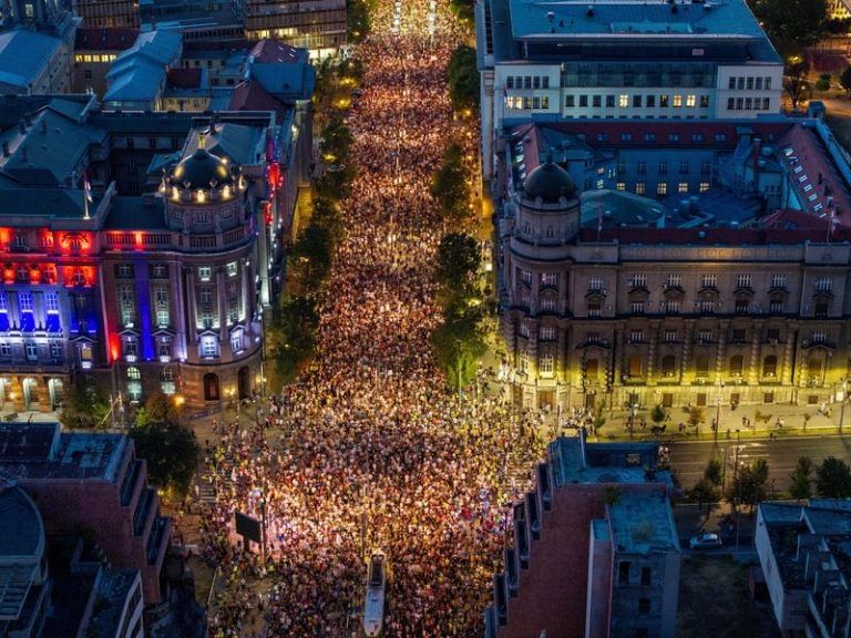 Tens of thousands march in Serbia’s capital, demand snap vote