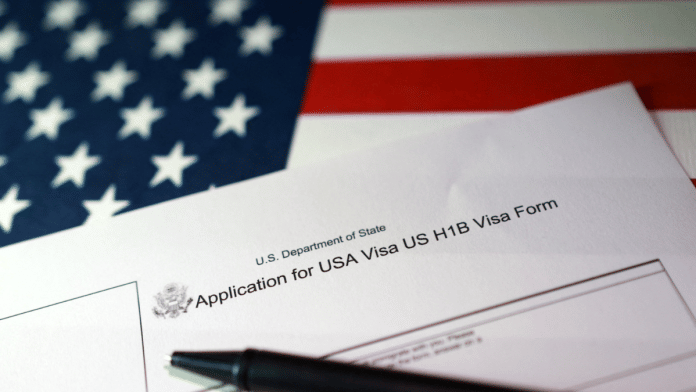 A U.S. flag and a U.S. H-1B Visa application form are seen in this illustration taken, on 22 September 2025. | Dado Ruvic | Illustration | Reuters