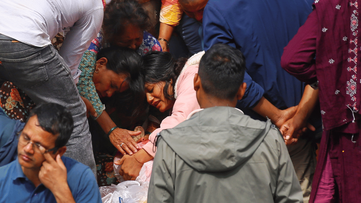 Bhimraj Dhami’s mother and wife (pink sweater) at the ghat. | Manisha Mondal/ThePrint