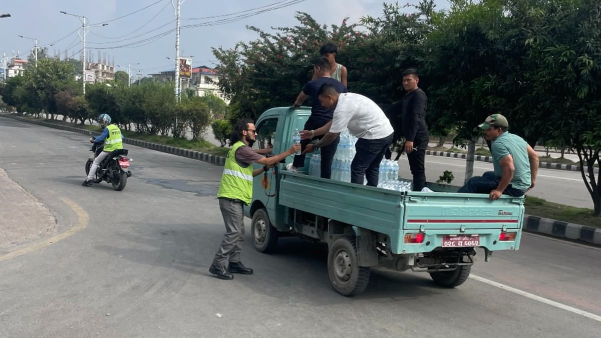 A group of volunteers handing out drinking water on a street in Kathmandu | Udit Hinduja | ThePrint