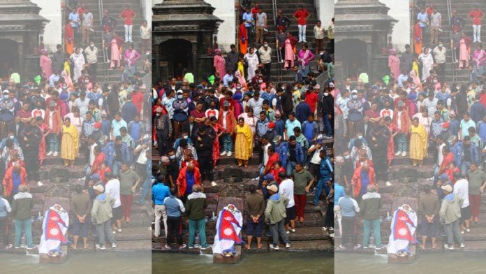 Body of Mahen Budhathoki, draped in the Nepali flag, kept on the banks of Bagmati river at Pashupatinath Ghat for last rites. | Manisha Mondal/ThePrint