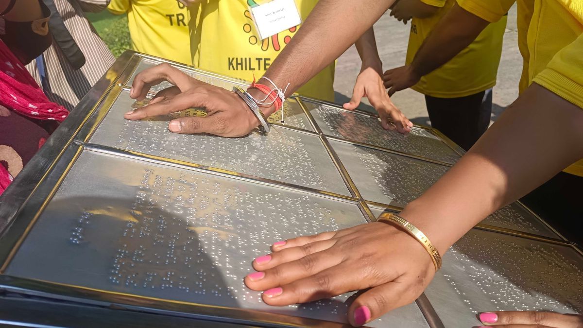 The group takes turns reading the Braille descriptions at the Taj Mahal | Almina Khatoon, ThePrint