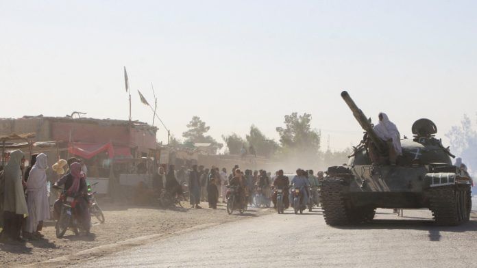An Afghan Taliban fighter sits on a tank near the Afghanistan-Pakistan border in Spin Boldak, Kandahar Province, following exchanges of fire between Pakistani and Afghan forces in Afghanistan, on 15 October, 2025| Reuters/Stringer