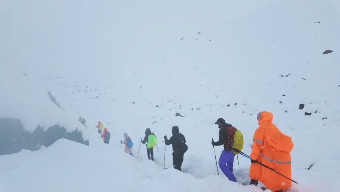 Everest A screen capture from video shows trekkers leaving their campsite, as unusually heavy snow and rainfall pummeled the Himalayas, in the Tibet Region on 5 October 2025. | Geshuang Chen | Handout via Reuters