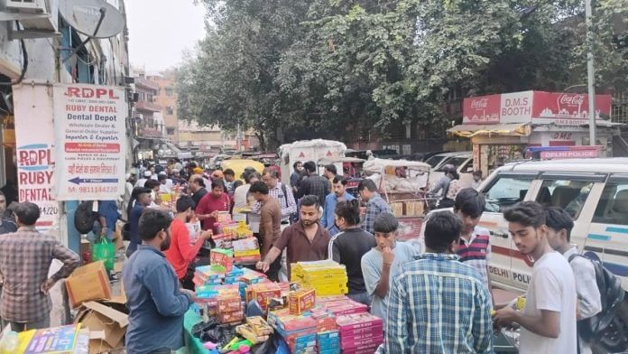 A crowd gathers near shops selling firecrackers near Jama Masjid in New Delhi on Friday | ThePrint/Aditya GV