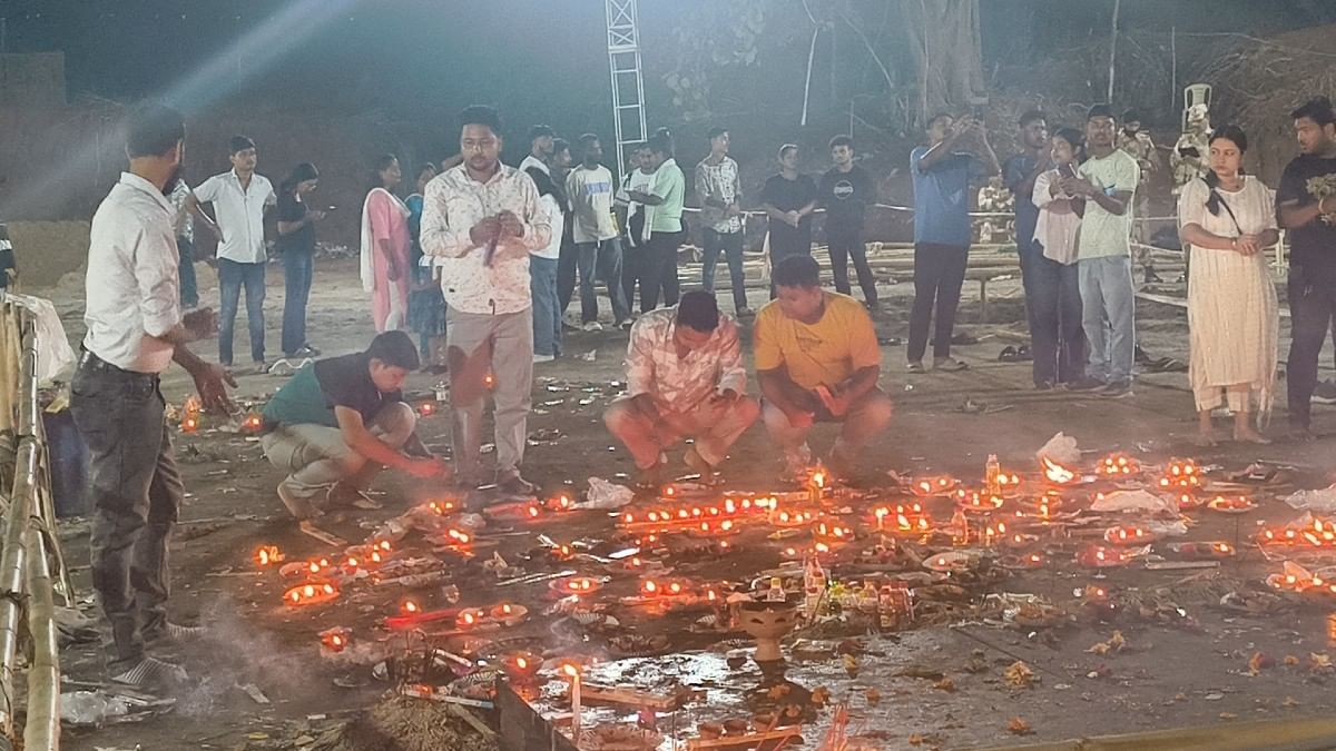 People lighting candles and diyas at the cremation site | ThePrint/Sourav Roy Barman