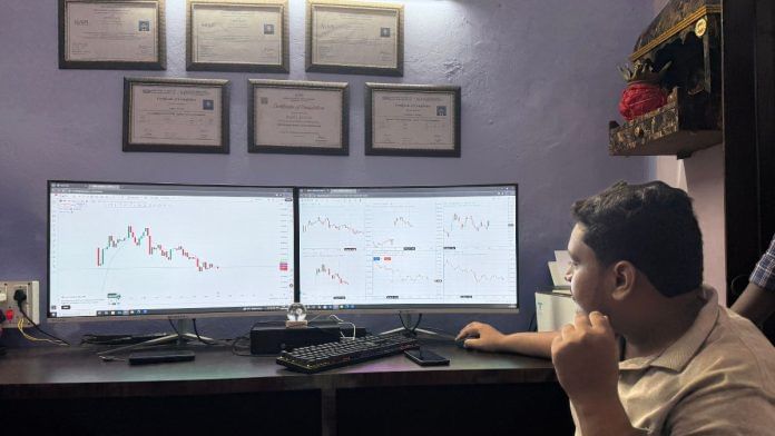 Priyanshu Kumar, 23, a Gen Z trader, scrolls through stock market charts on the ground floor of a 70-year-old house in Babu Bazar, Ara | Photo: Jyoti Yadav, ThePrint