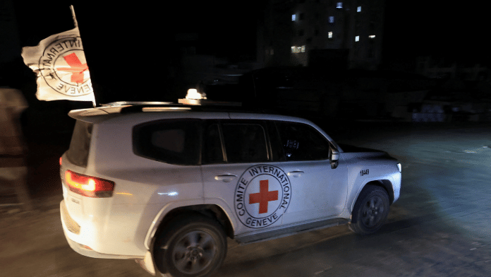 red cross car Red Cross transports the body of a deceased hostage, who had been held in Gaza since the deadly October 7, 2023, attack, after it was handed over by Hamas militants as part of a ceasefire and a hostages-prisoners swap deal between Hamas and Israel, in Gaza City, October 27, 2025 | Reuters
