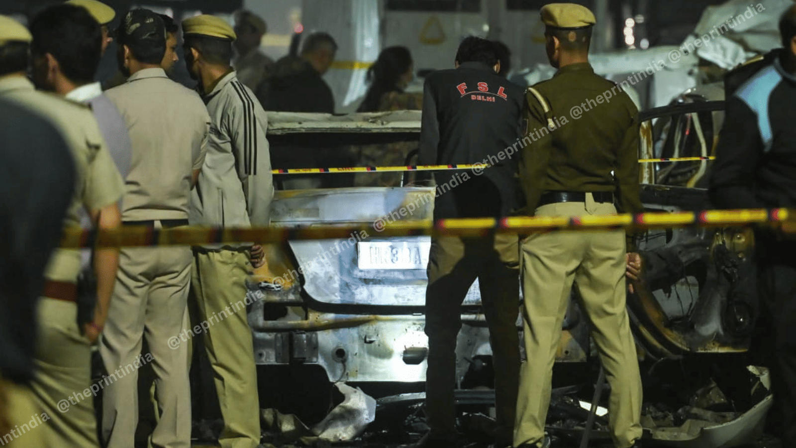 Police barricade the blast site, remnants of a charred vehicle can be seen in the background | ThePrint/Suraj Singh Bisht