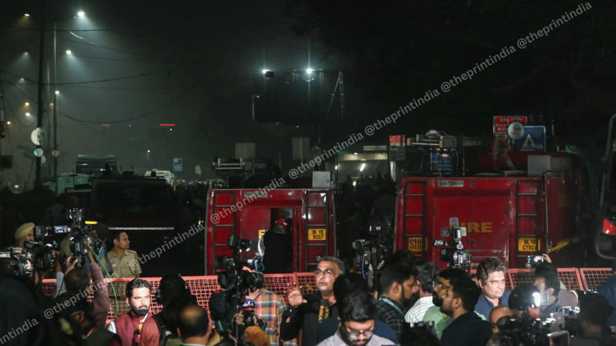 Reporters and investigators near the blast site on Monday evening | ThePrint/Suraj Singh Bisht
