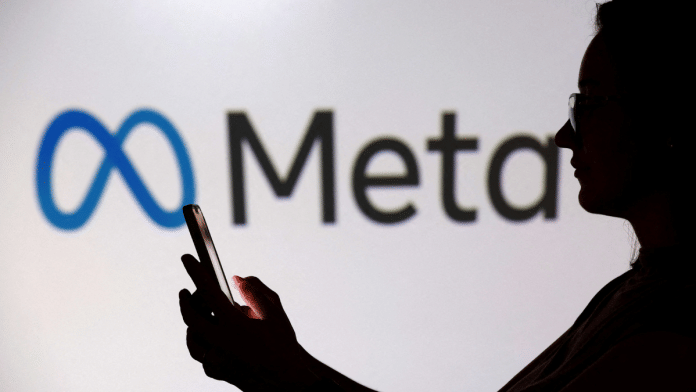 A teenager poses for a photo while holding a smartphone in front of a Meta logo in this illustration taken September 11, 2025 | File photo | Reuters