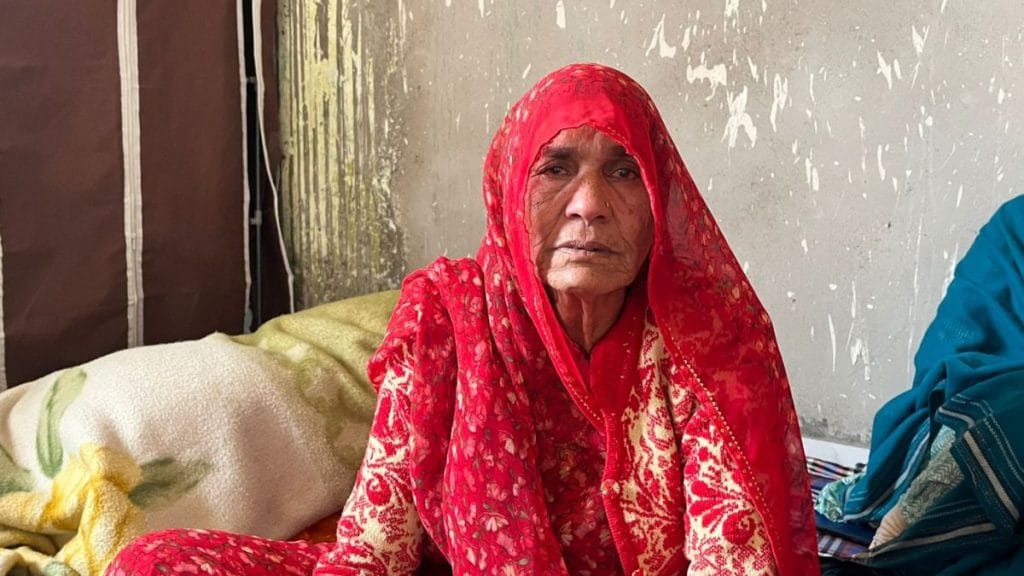 65-year-old Kamla, Mukesh’s mother, sitting on the floor with others. Photo: Nootan Sharma | ThePrint