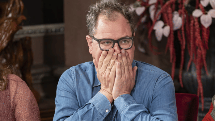 Alan Carr worried about how his ‘sweating problem’ would affect his Traitors performance. | Euan Cherry | Studio Lambert | BBC via The Conversation