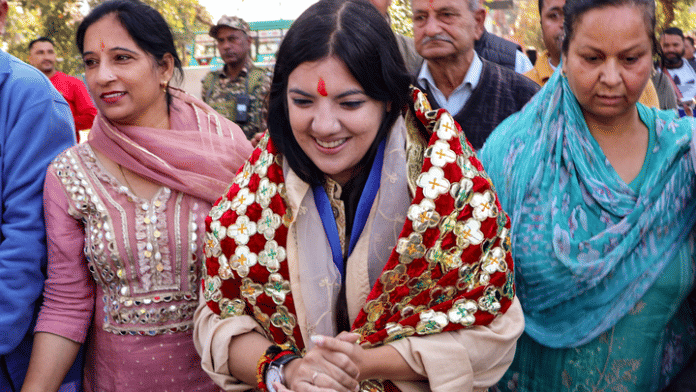 BJP candidate Devyani Rana interacts with voters at a polling booth during the Nagrota assembly constituency bypoll on 11 November 2025 | PTI