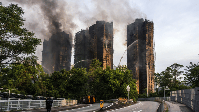 Smoke rises from residential buildings as fires continue to burn at Wang Fuk Court on Nov. 27 | Bloomberg