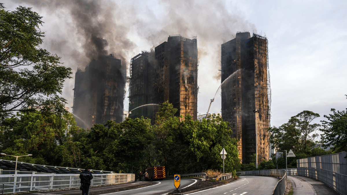 Smoke rises from residential buildings as fires continue to burn at Wang Fuk Court on Nov. 27 | Bloomberg