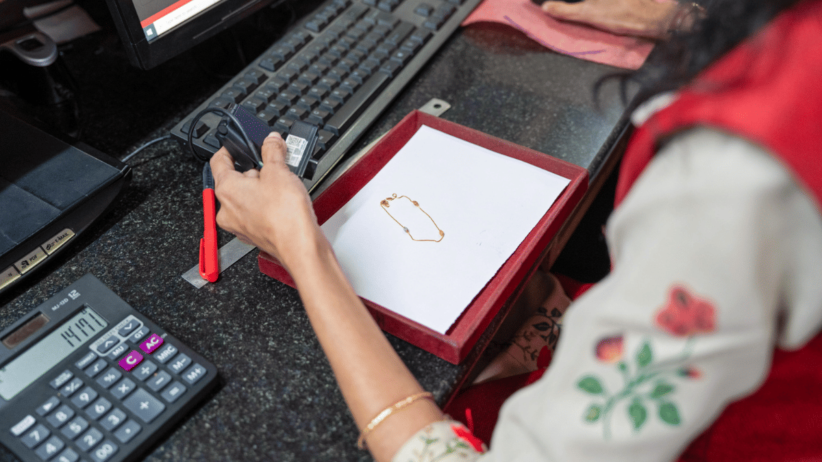 Clients bring their jewelry to a branch, where staff check the gold content before making a loan of up to 75% of the value | Sameer Raichur/Bloomberg