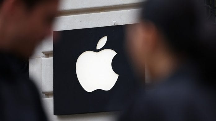 Representational | File photo of people walking past an Apple store in Paris | Abdul Saboor/REUTERS
